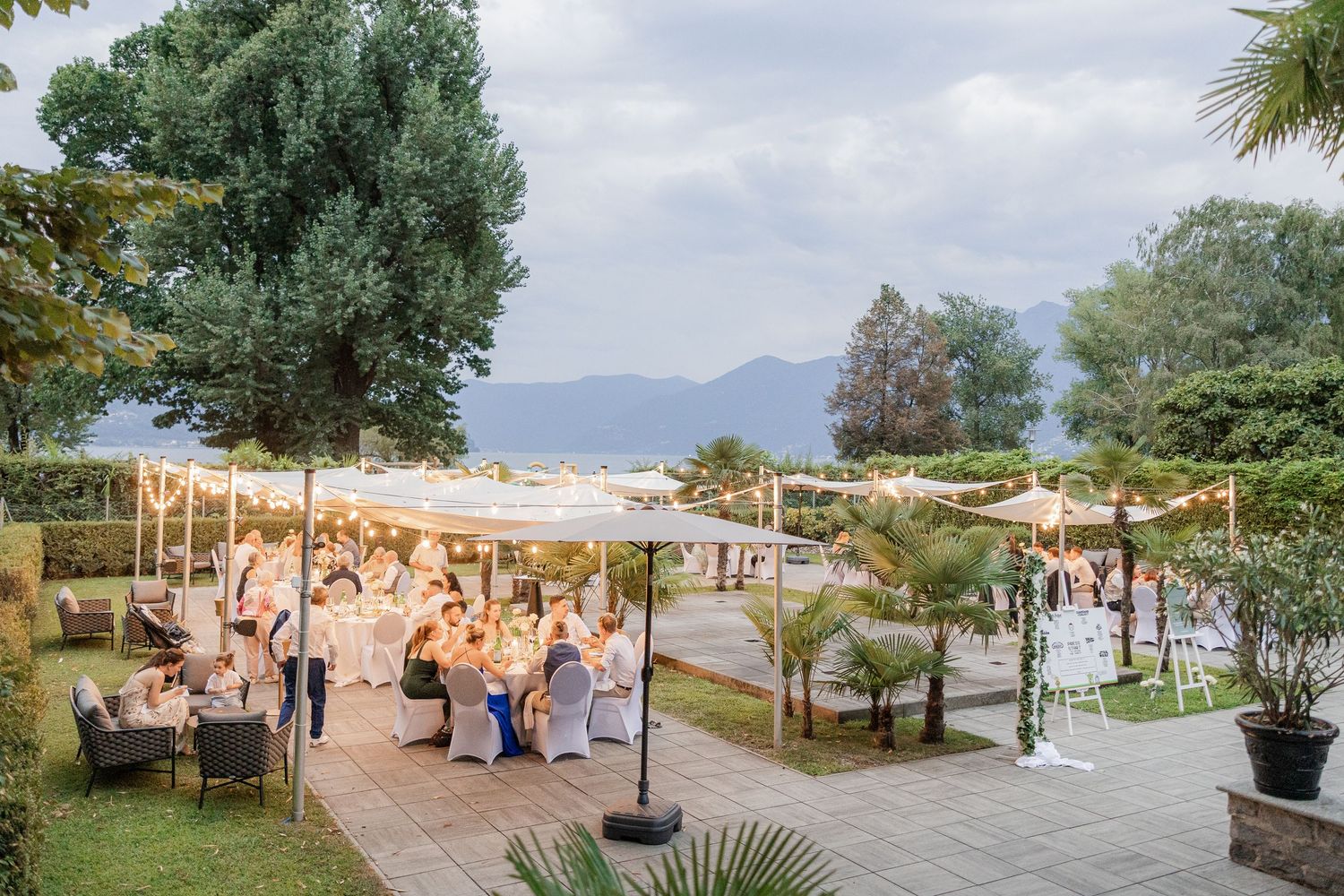 Panoramic sequence of a Mediterranean beach resort setting with palm trees, sandy shoreline and seaside lounge areas.