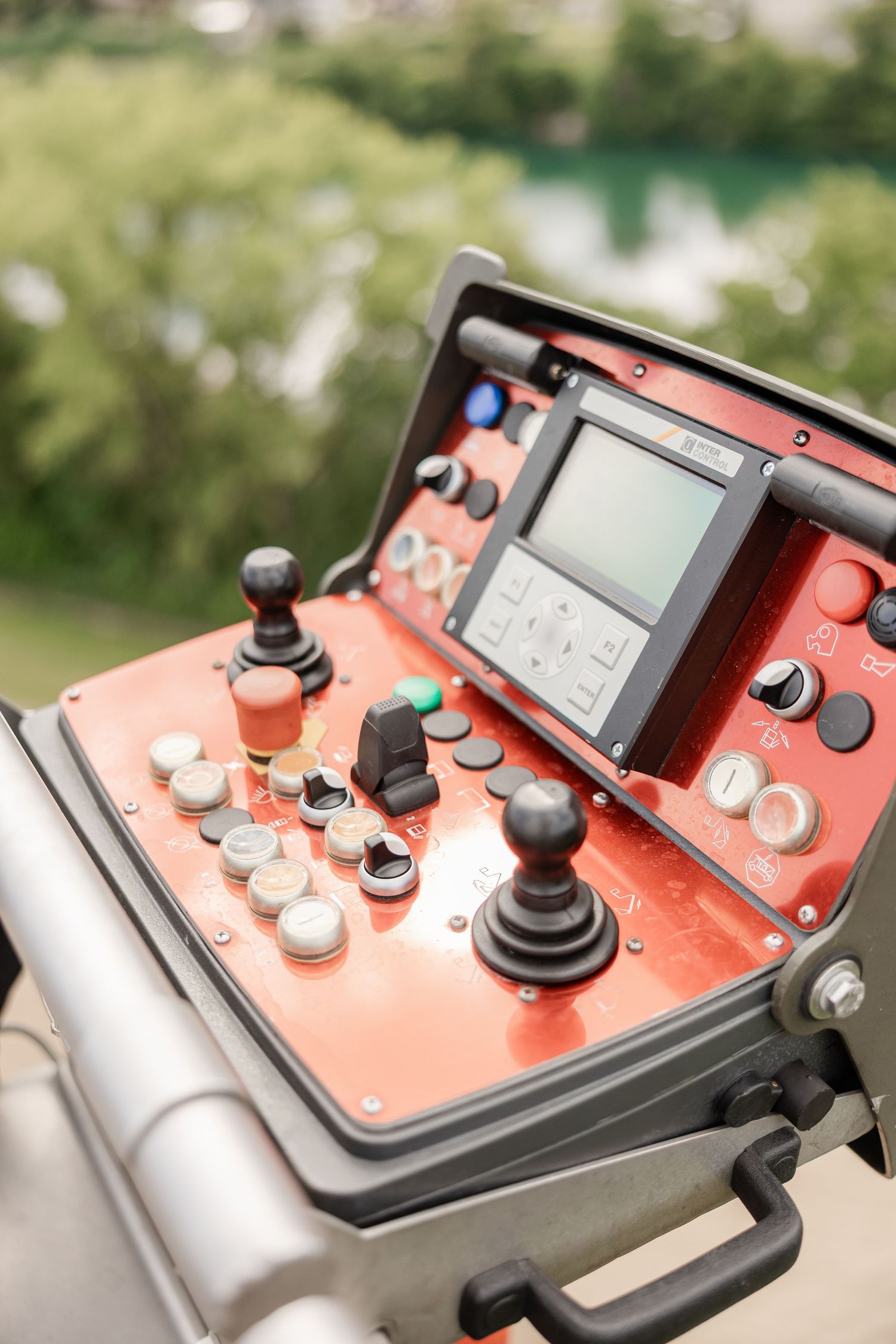 Close-up shots of a red and silver control panel with multiple knobs and buttons.