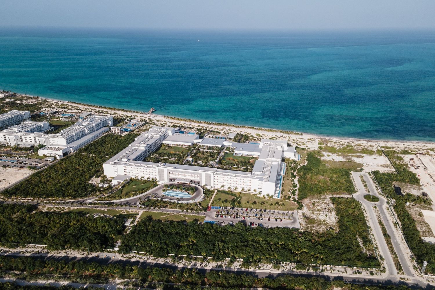 Aerial view of Grand Palladium resort nestled along a turquoise coastline.