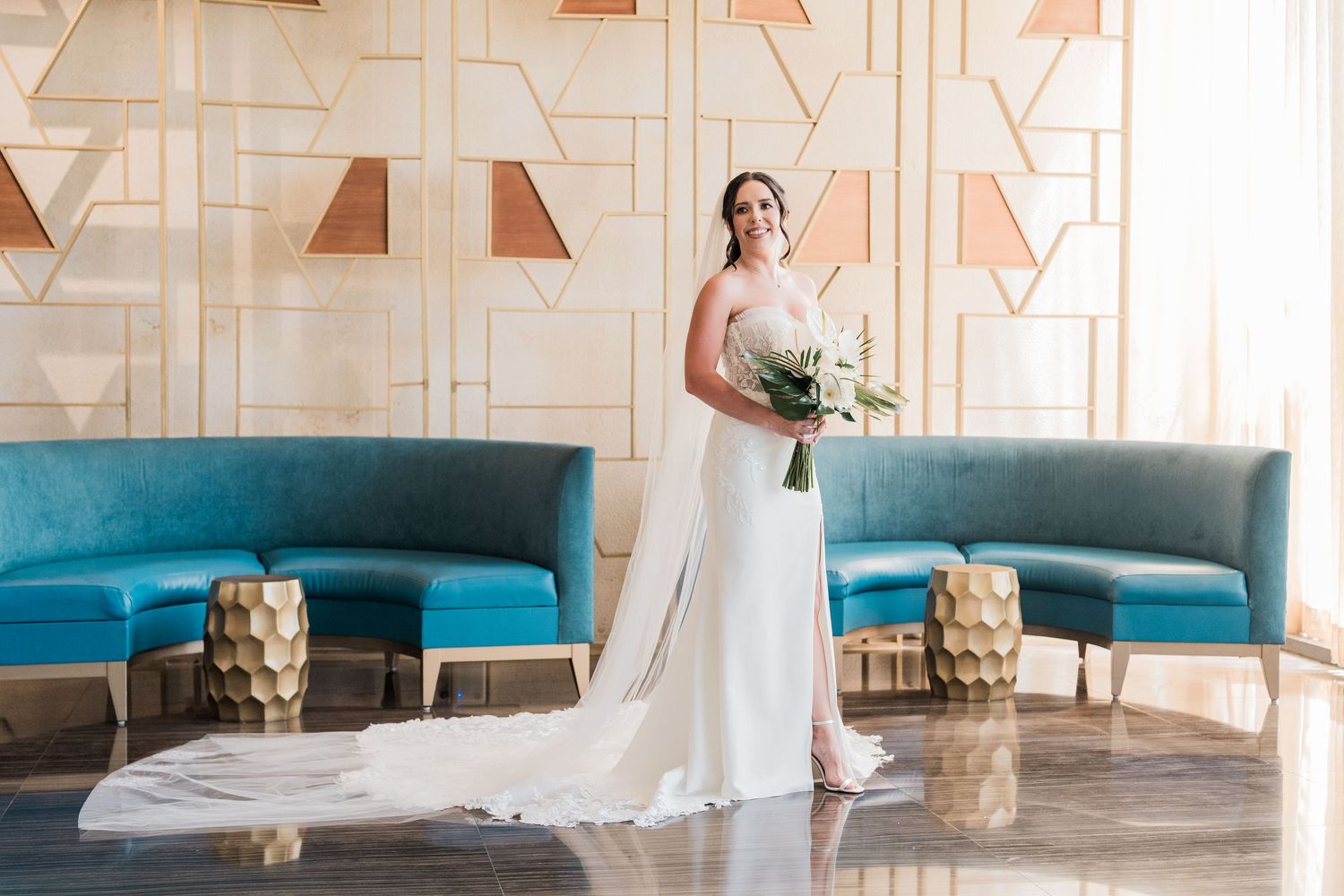 Bride in white gown holding bouquet poses in grand palladium costa mujeres wedding