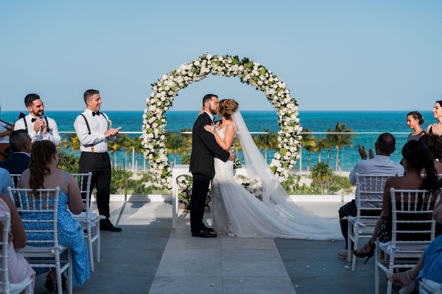 Riu Palace Costa Mujeres Wedding - bride and groom first kiss Caribbean ocean background