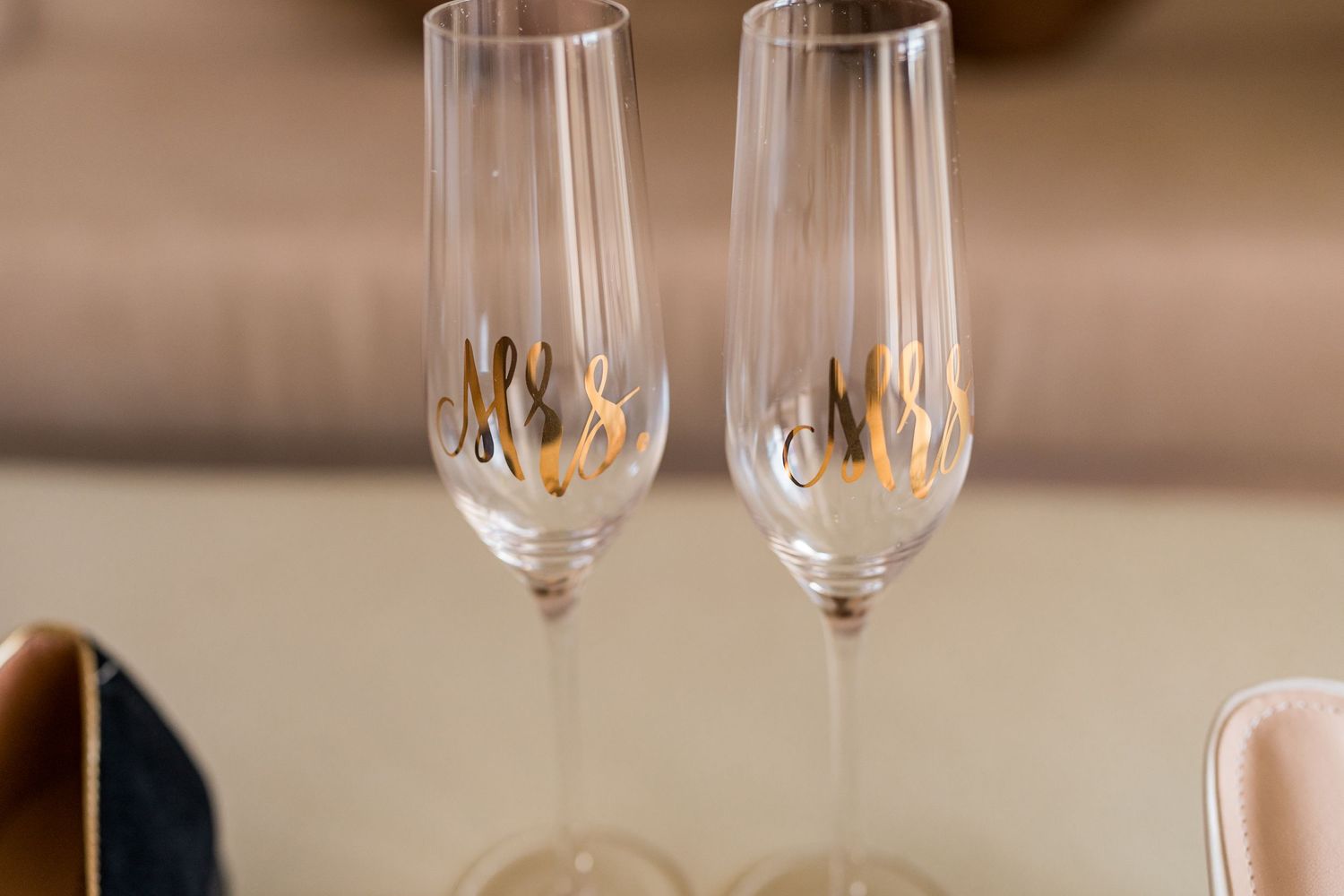 Two champagne flutes engraved with Mrs and Mrs for a same-sex wedding celebration.