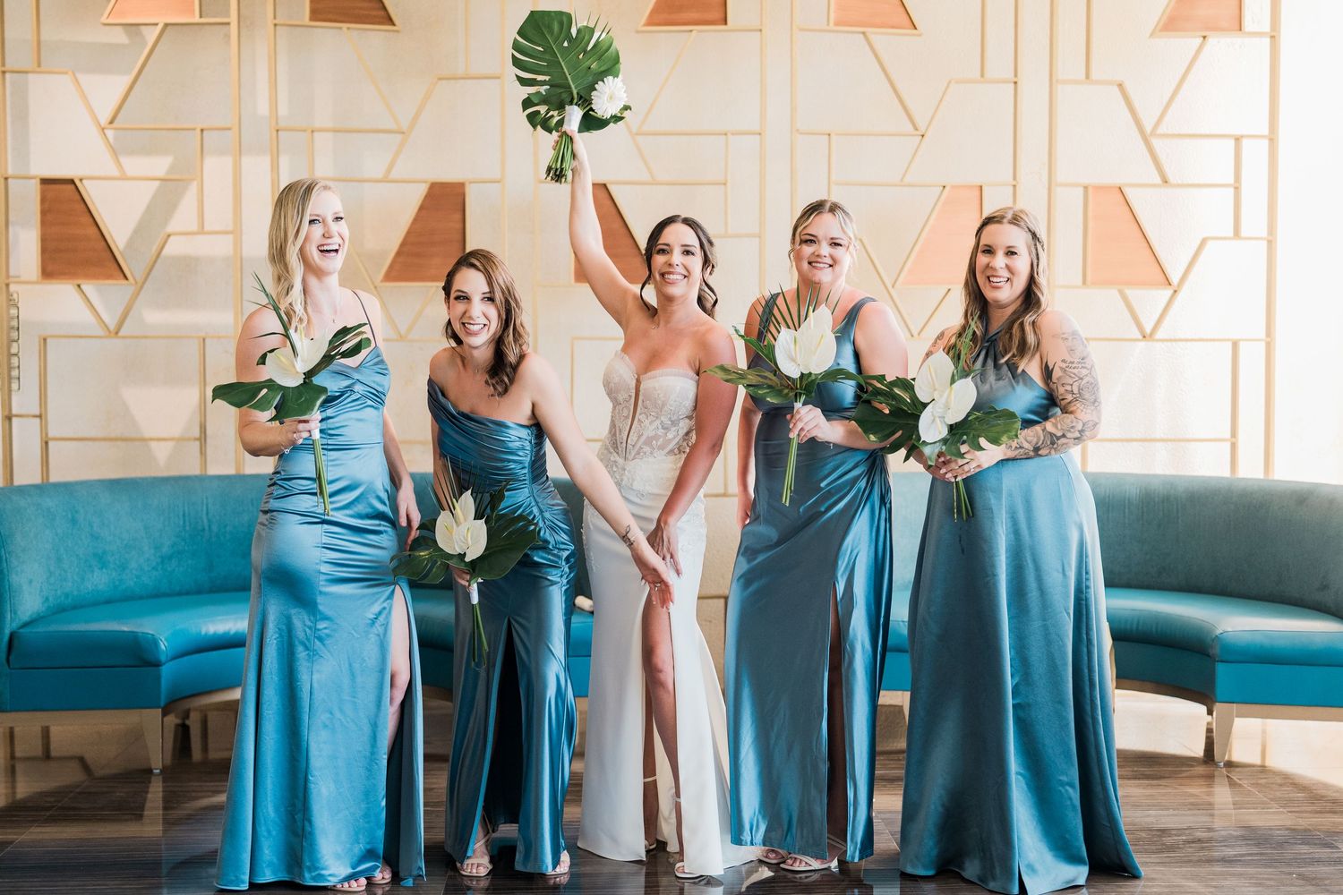 Bride in white gown with bridesmaids in blue satin dresses in grand palladium costa mujeres wedding