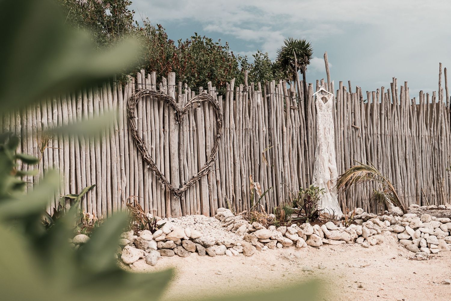 blue venado seaside wedding details, dress on a wood wall - riviera Maya wedding photographer and filmmaker