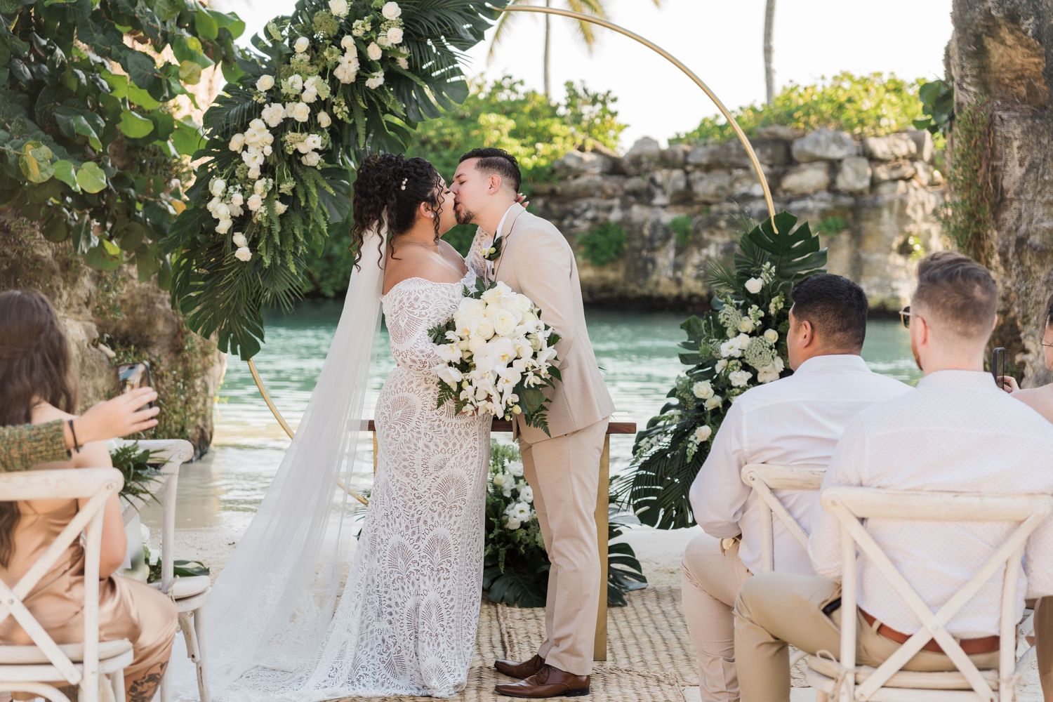 Xcaret Arte Wedding - Couple kissing at tropical outdoor wedding ceremony