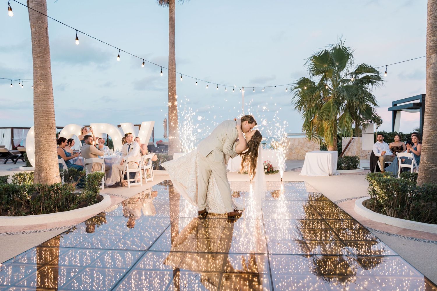 cancun wedding  photographer and filmmaker - bride and groom first dance with sparklers in background