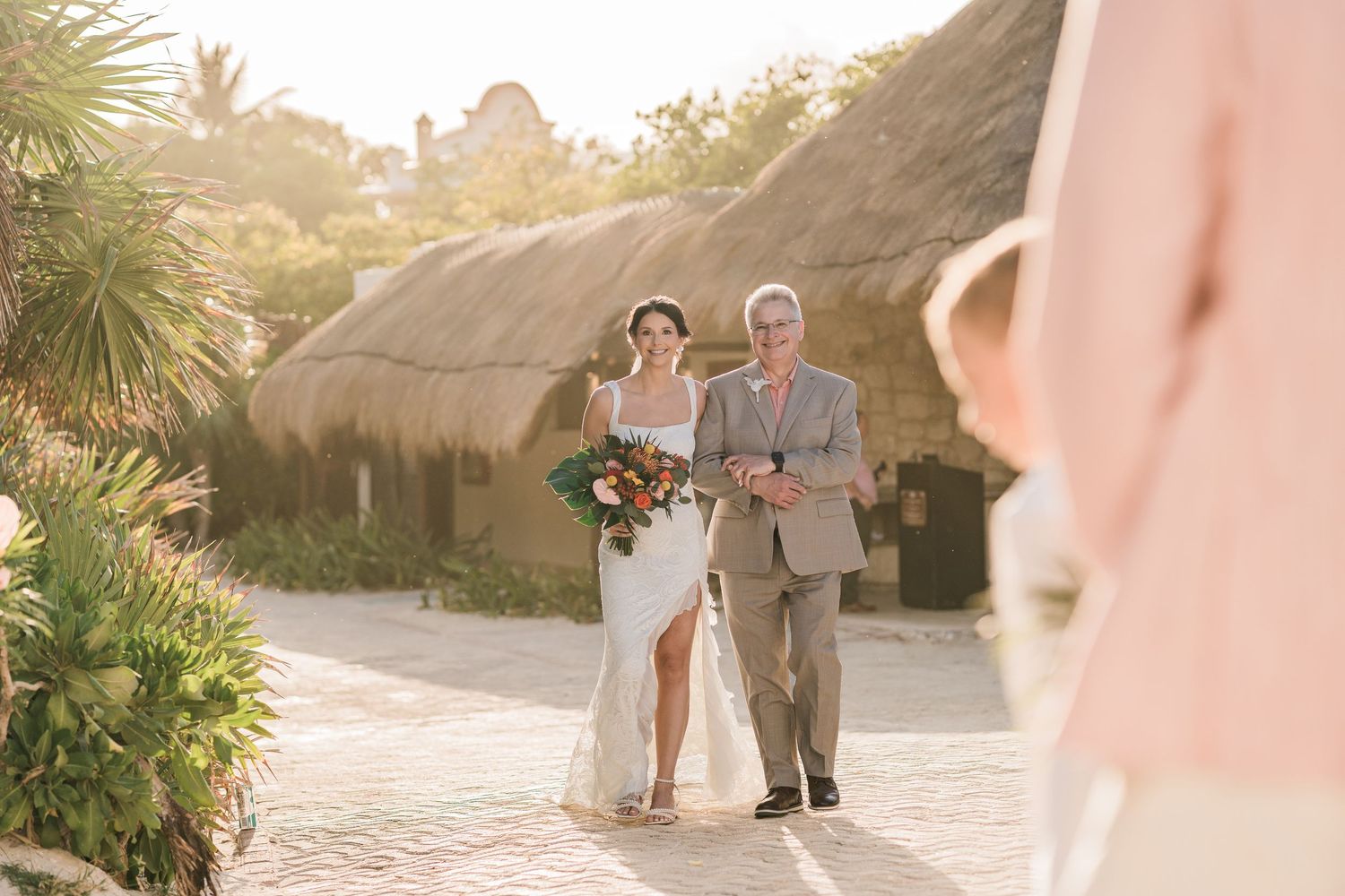 Bride walks down outdoor aisle at a tropical destination wedding. Puerto Vallarta wedding photographer