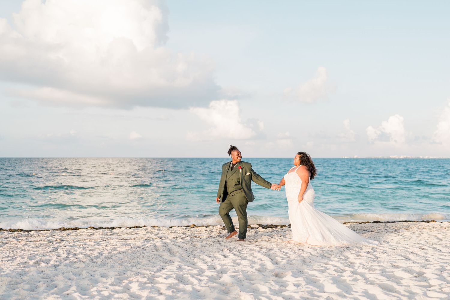 Secrets Playa Mujeres Golf & Spa Resort same sex wedding - brides walking at the beach