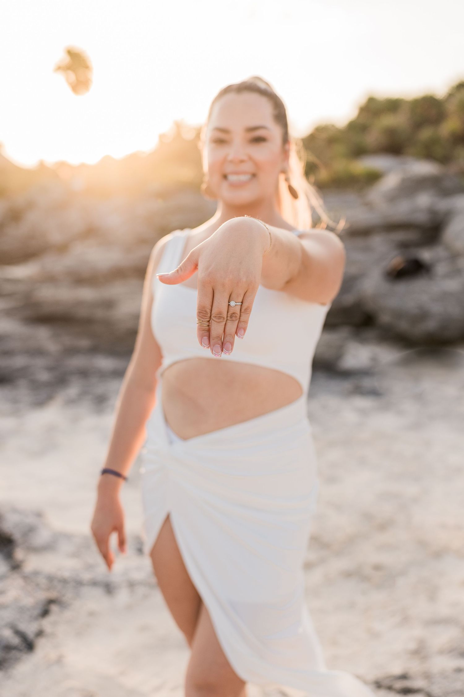 Sunset couple photoshoot, bride showing ring after a marriage proposal photoshoot at the beach