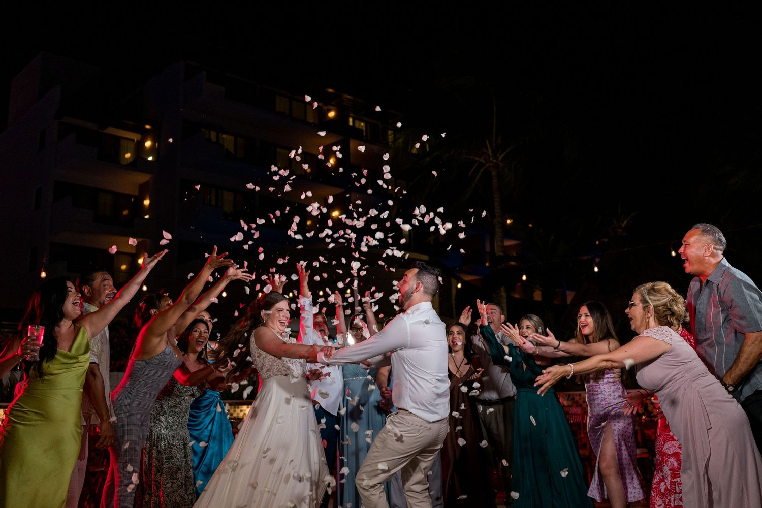 Couple celebrating with rose petals in the air