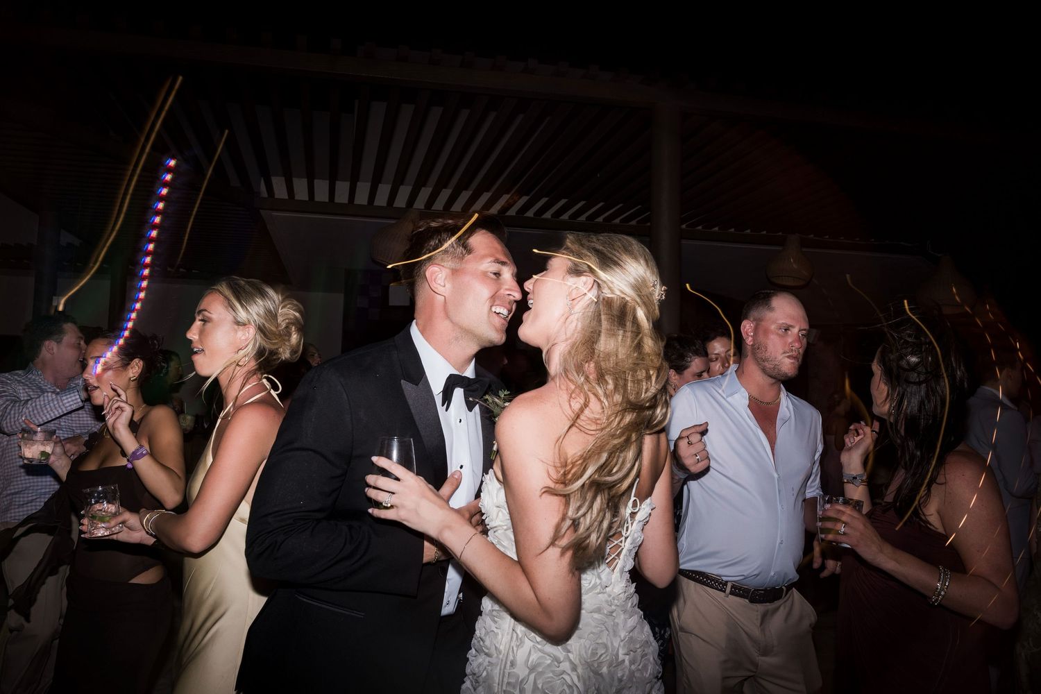 Bride and groom share a joyful dance together at their wedding reception surrounded by guests. TRS Yucatán Hotel Wedding