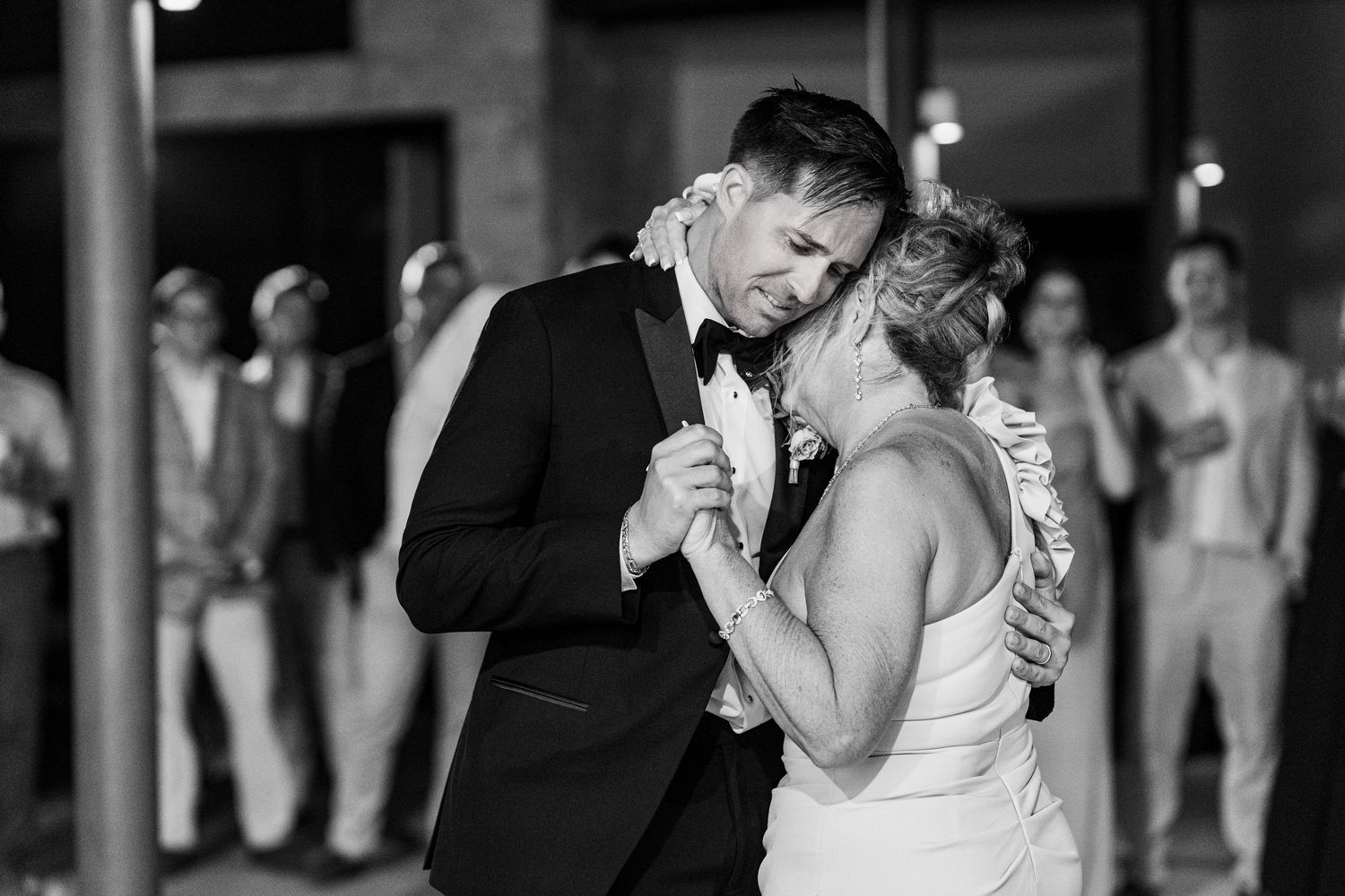 Black and white photo of bride and groom sharing an intimate first dance at their wedding reception.