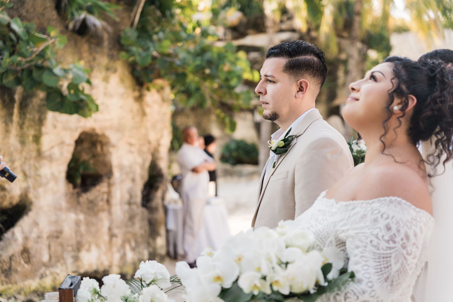 Xcaret Arte Wedding - Bride and groom stand together during outdoor wedding ceremony