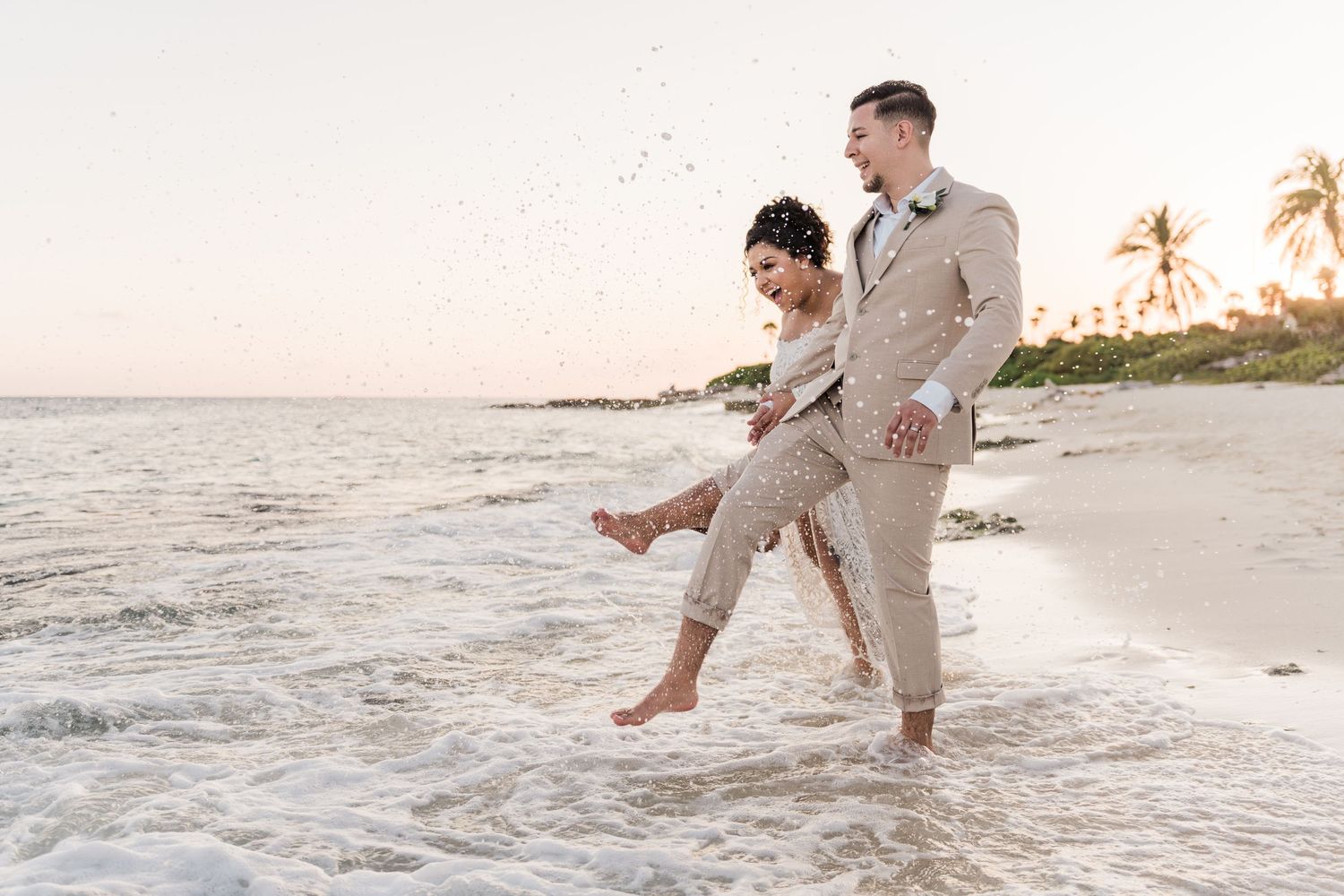 cancun wedding  photographer and filmmaker - bride and groom at the beach having fun