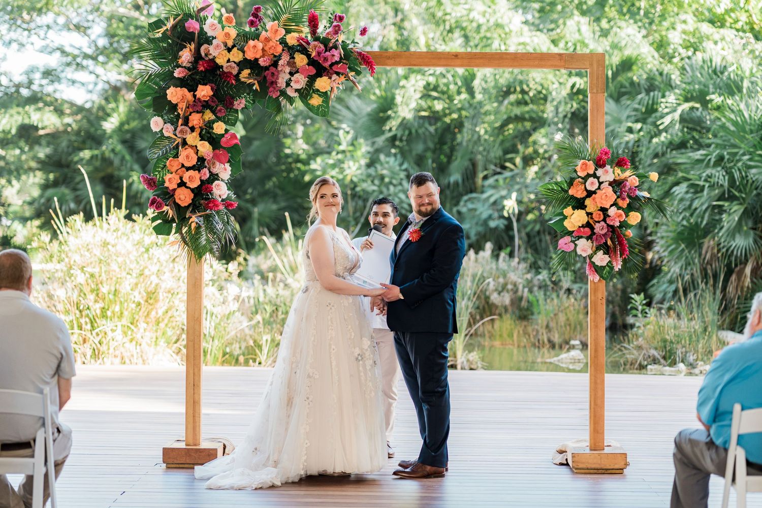 Secrets Akumal Wedding - Couple exchanges vows under a wooden arch