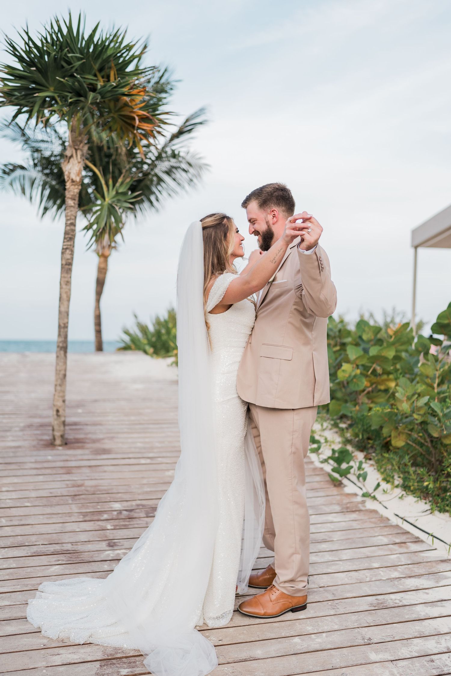 Bride and groom share first dance with ocean backdrop at tropical beach wedding. Puerto Vallarta wedding photographer