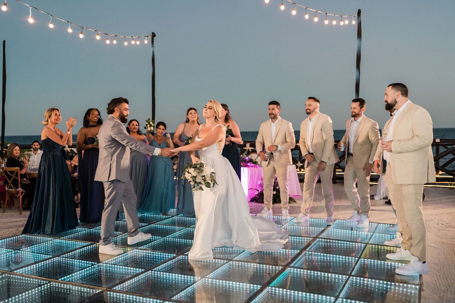 Bride and groom dancing on illuminated glass dance floor at Hard Rock Riviera Maya