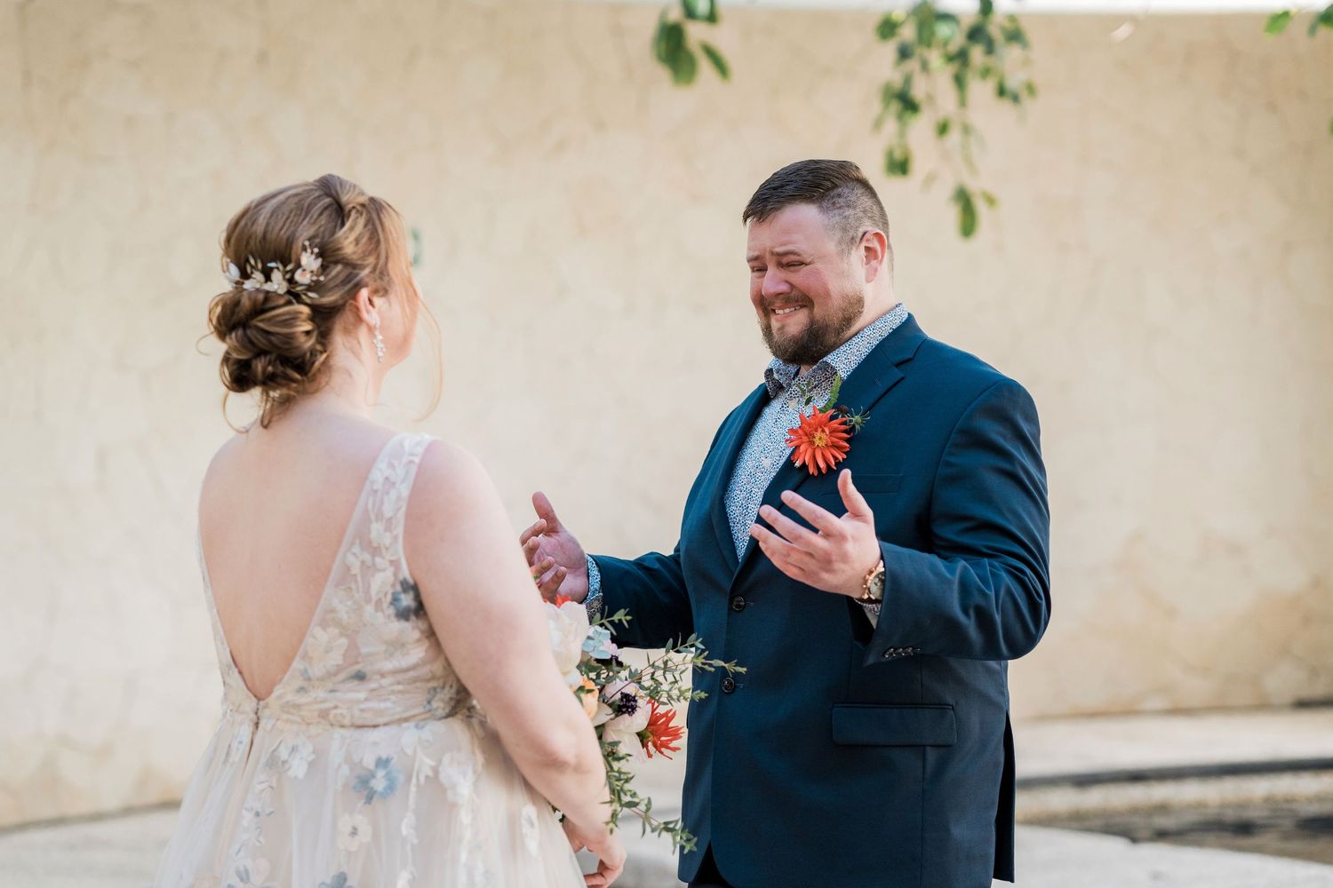 Secrets Akumal Wedding - Groom in navy suit smiling at bride during outdoor wedding ceremony