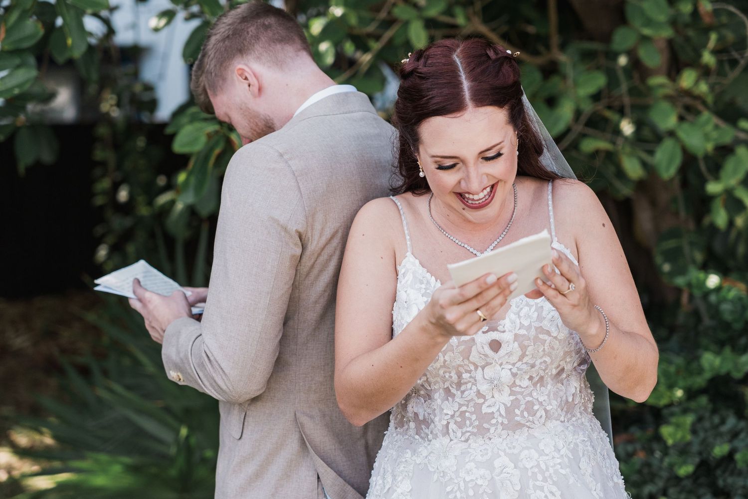 Bride and groom read private letters back-to-back during emotional first look wedding moment.