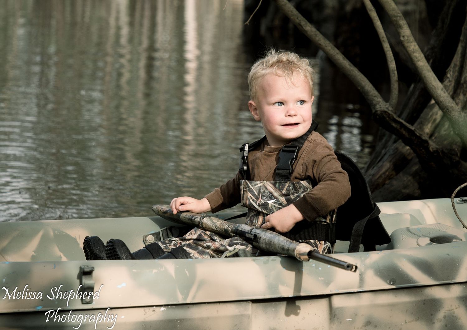 Photograph of boy Child duck hunting in kayak in Brunswick County NC