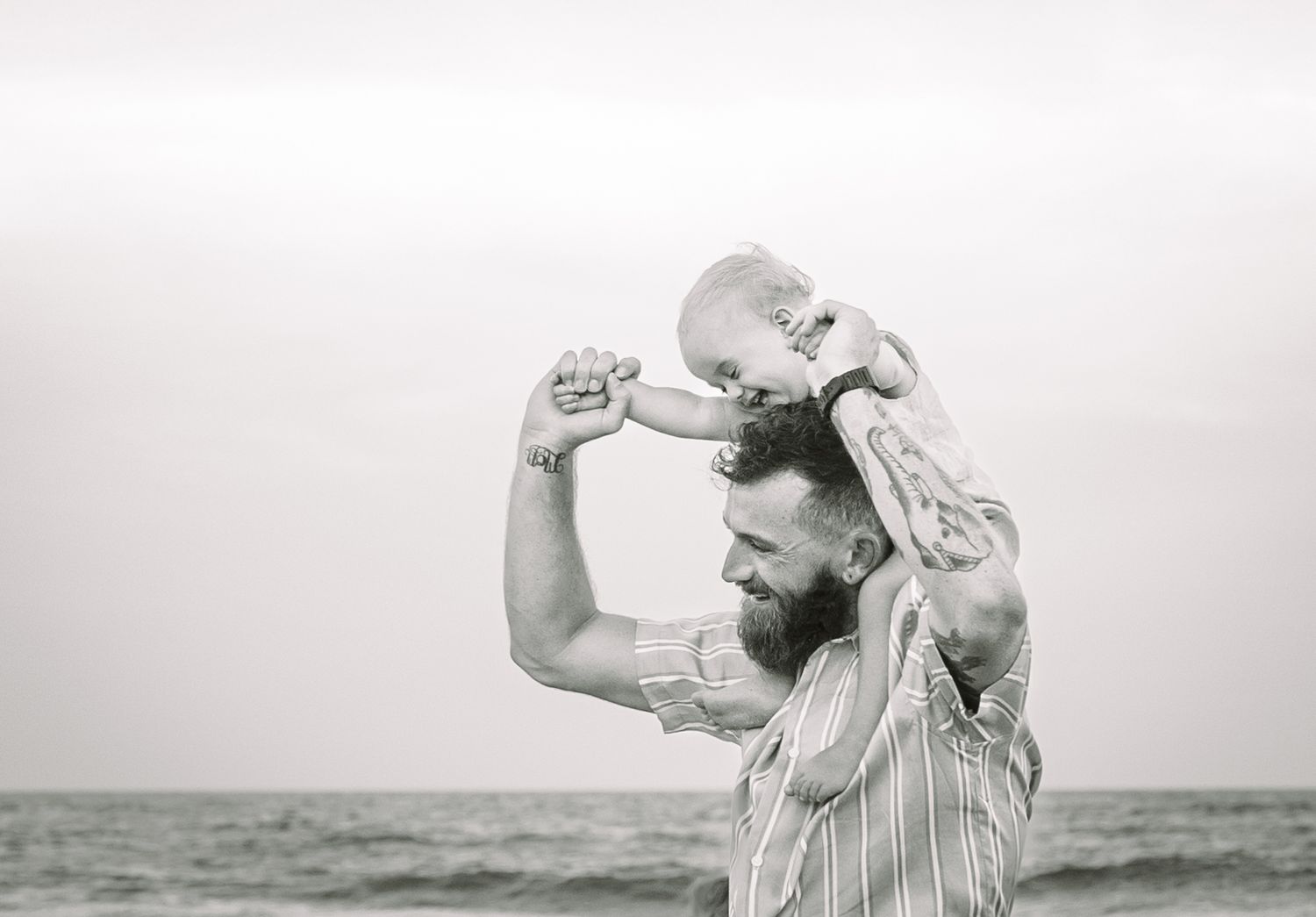 Family lifestyle photograph with Dad and son at the beach Wrightsville Beach, NC