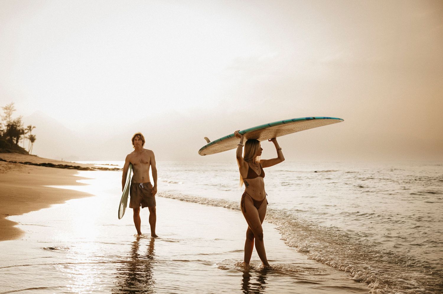 Golden hour sunset surfer couple beach photos taken in Maui by Wilmington, NC photographer