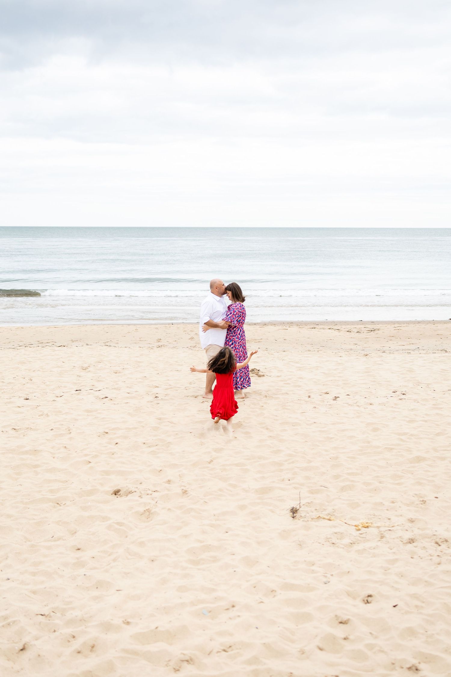 Pre-wedding family photoshoot in Gorey, Wexford — joyful beach moments with parents and their 4-year-old daughter.