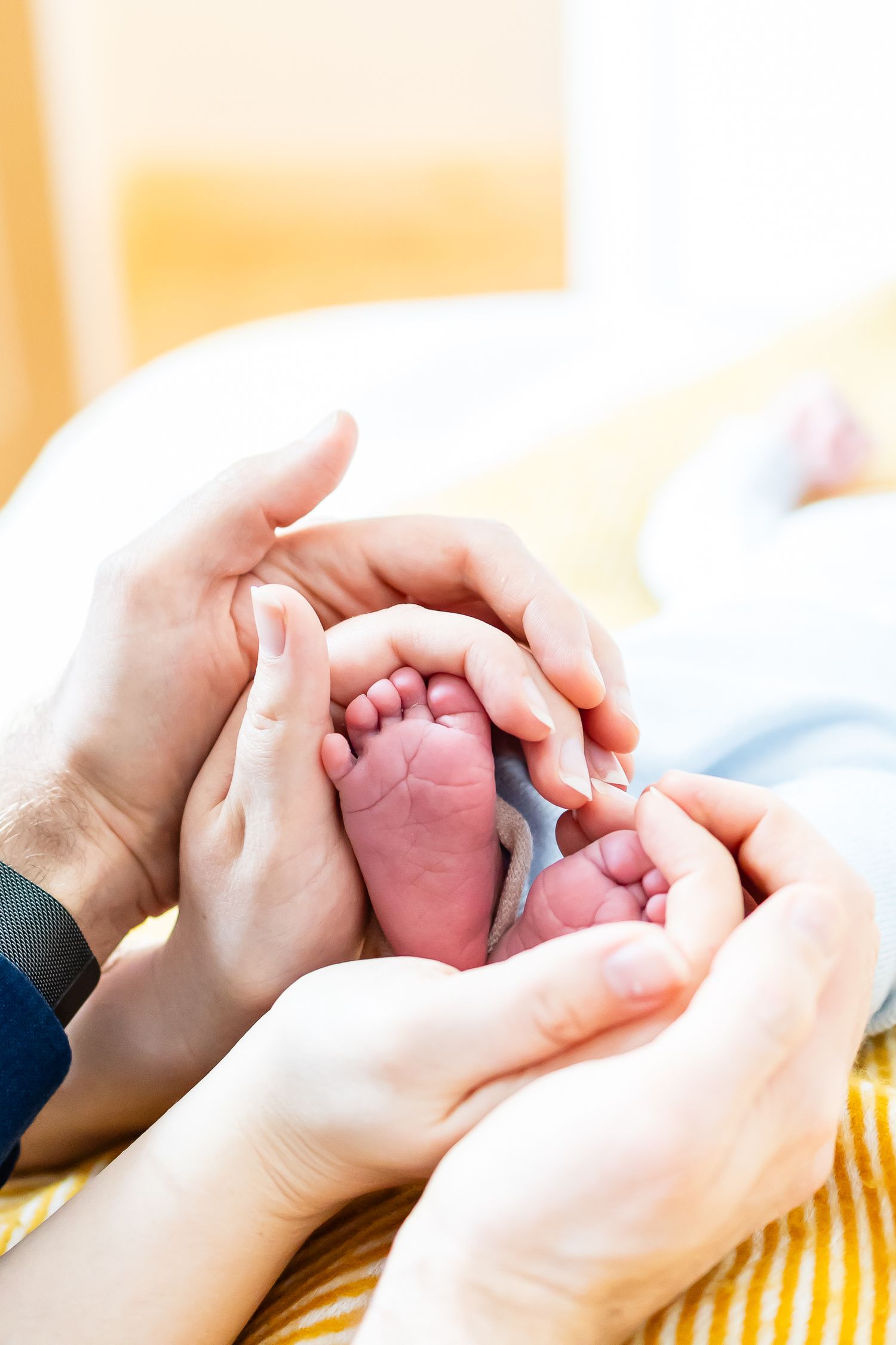 At-home baby photoshoot in Dublin — capturing one-month-old’s first moments with loving parents in a warm, intimate setting by LR Photograph