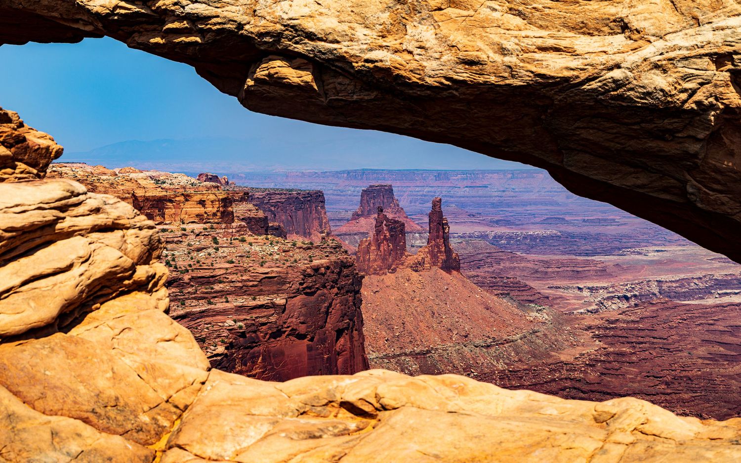 Mesa Arch frames a stunning desert canyon vista in Canyonlands National Park.