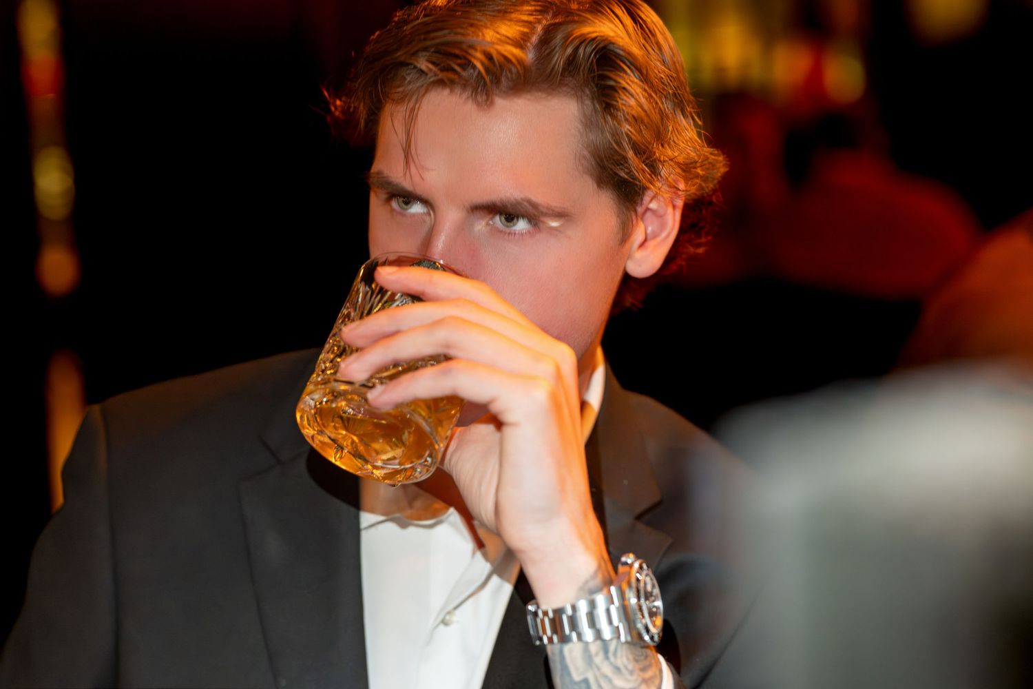 A sequence of similar photos showing someone taking a bite of a sandwich or burger in a dimly lit setting.