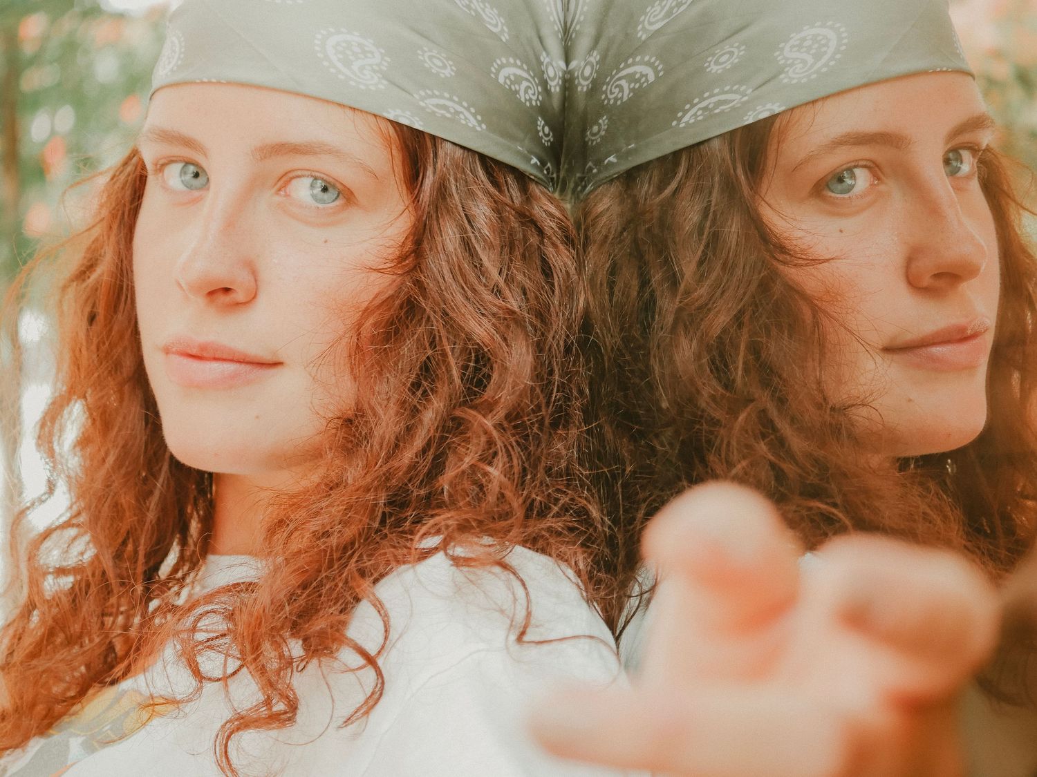 A person with curly red hair posing against a sunlit background in a multiple shot collage.
