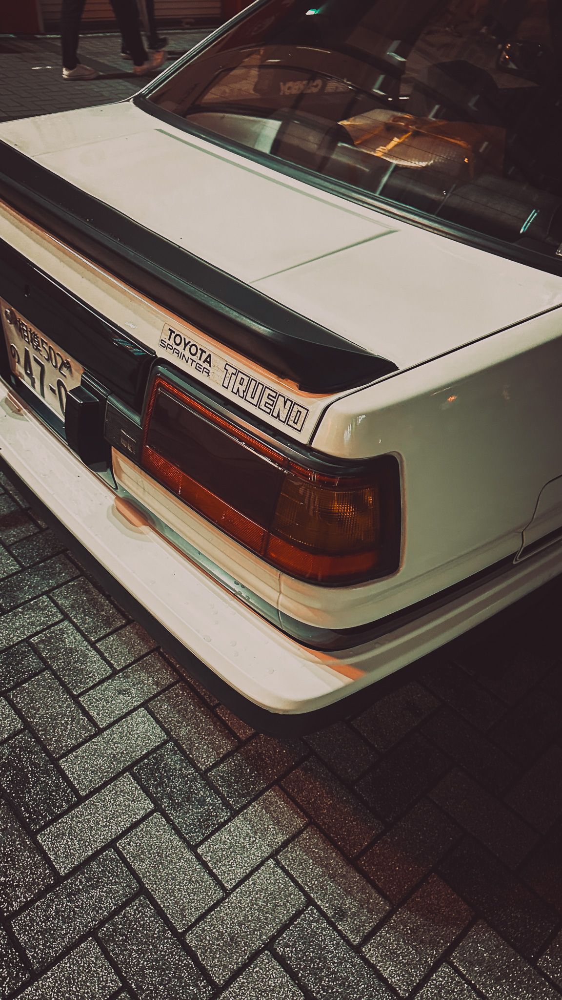 Close-up view of a white Toyota Trueno rear end showing distinctive taillights and badging.