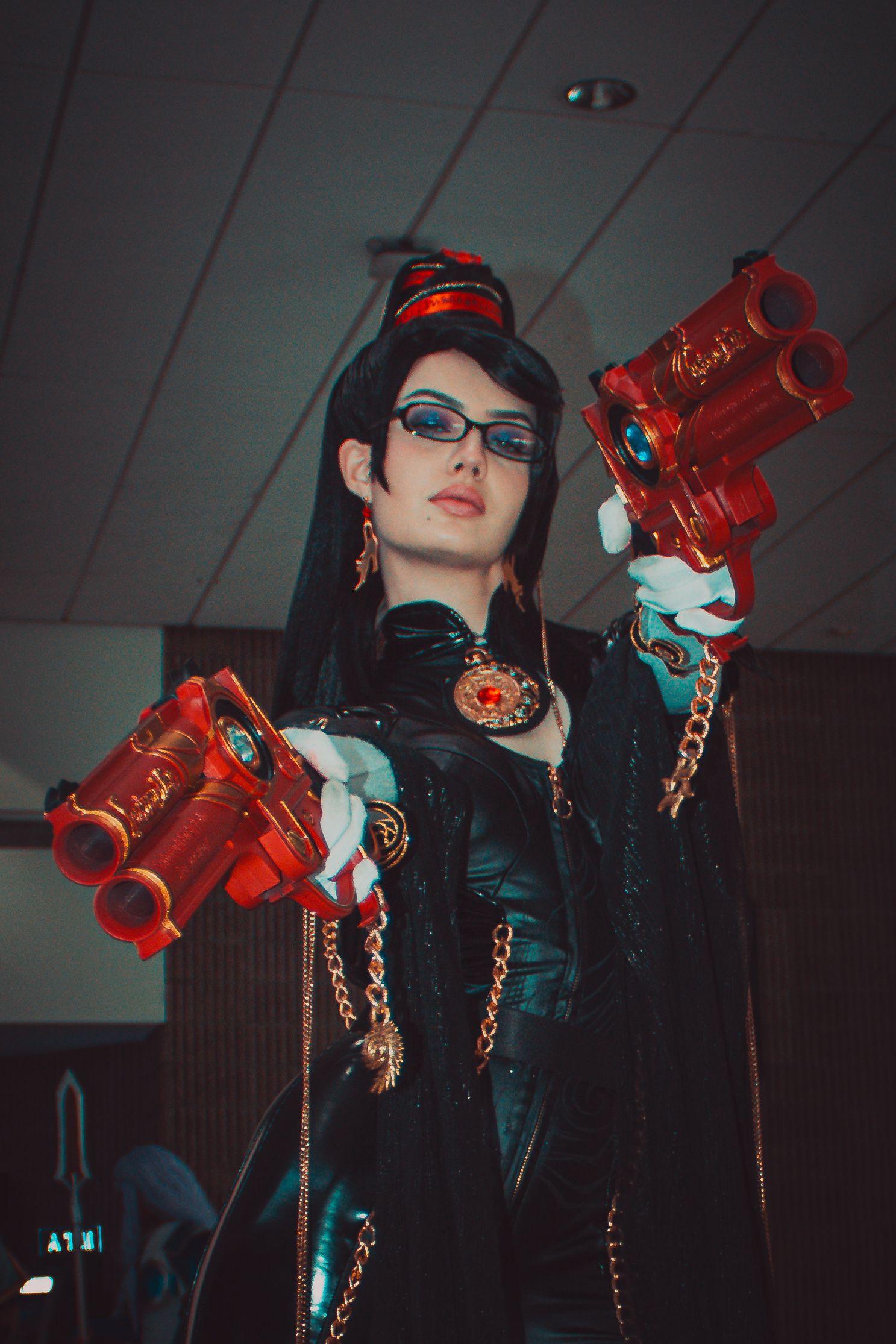 Stylized cosplay photoshoot featuring poses with red props against an industrial interior setting.