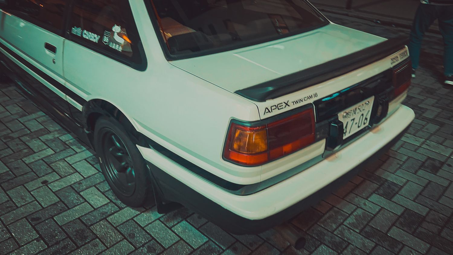 Side profile of a white vintage performance car showing distinctive body lines.