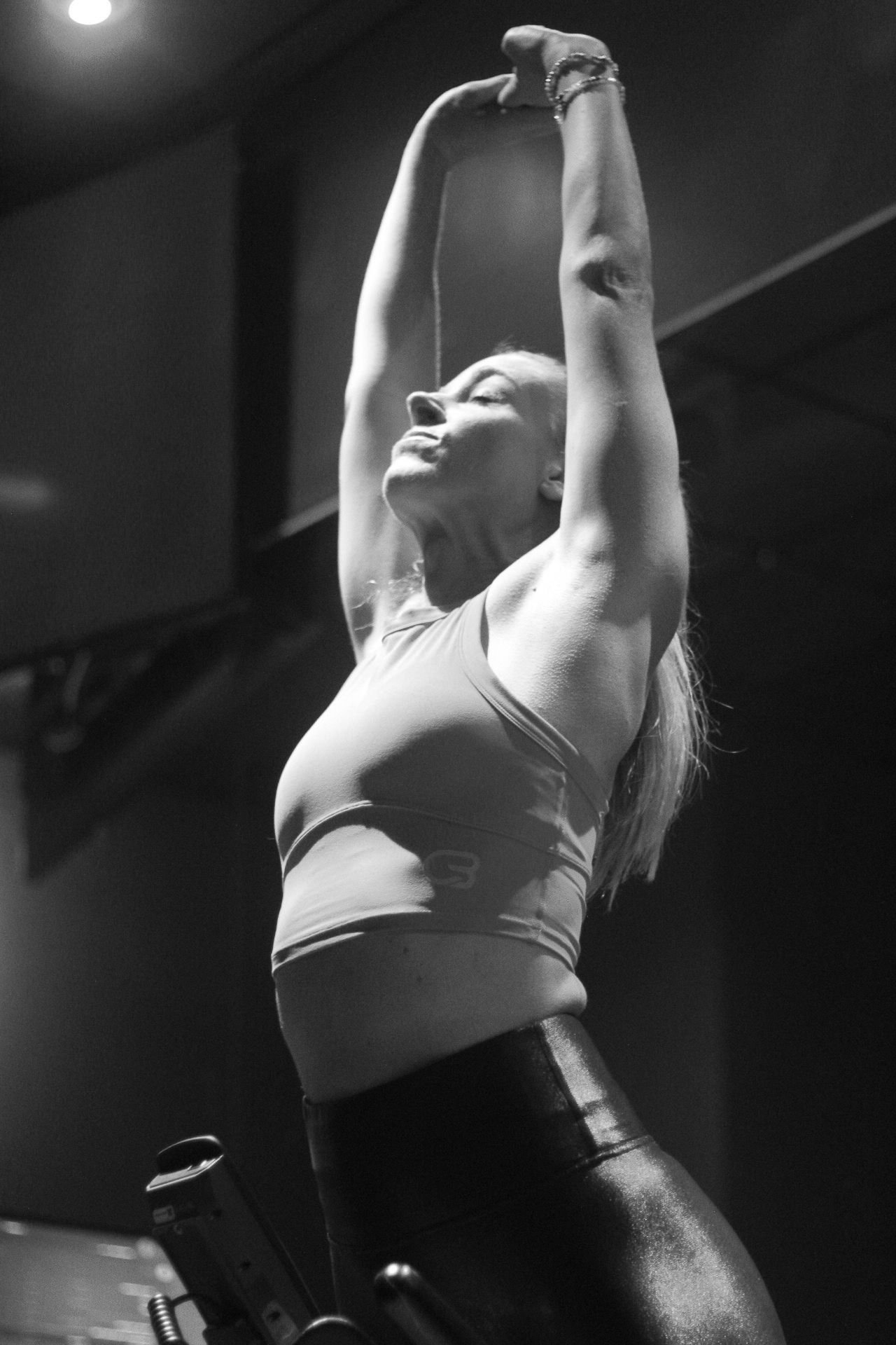 Katie Brantley stretches with arms overhead after a Cyclebar class