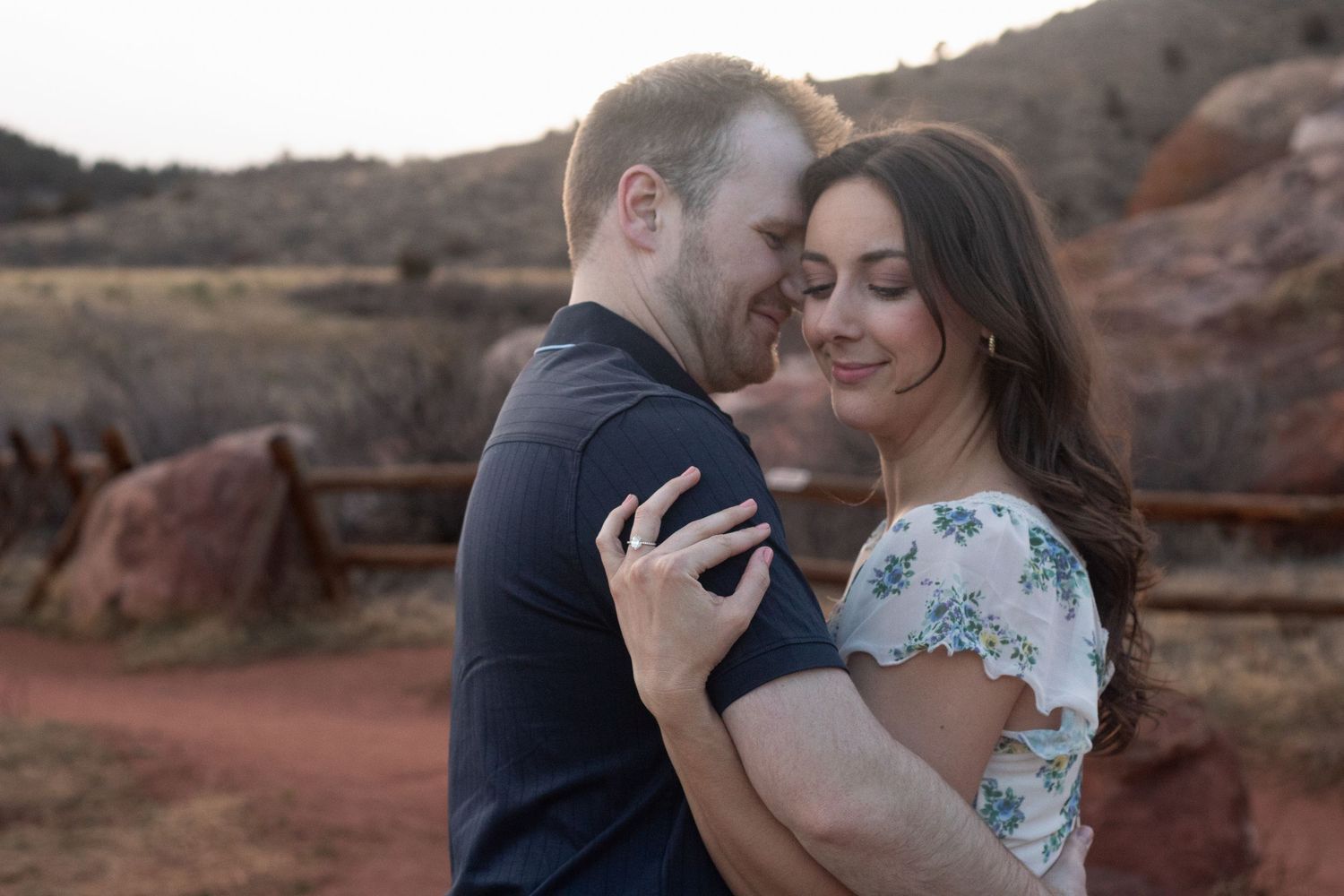 A romantic engagement photo shoot at sunset at Red Rocks in Morrison, Colorado