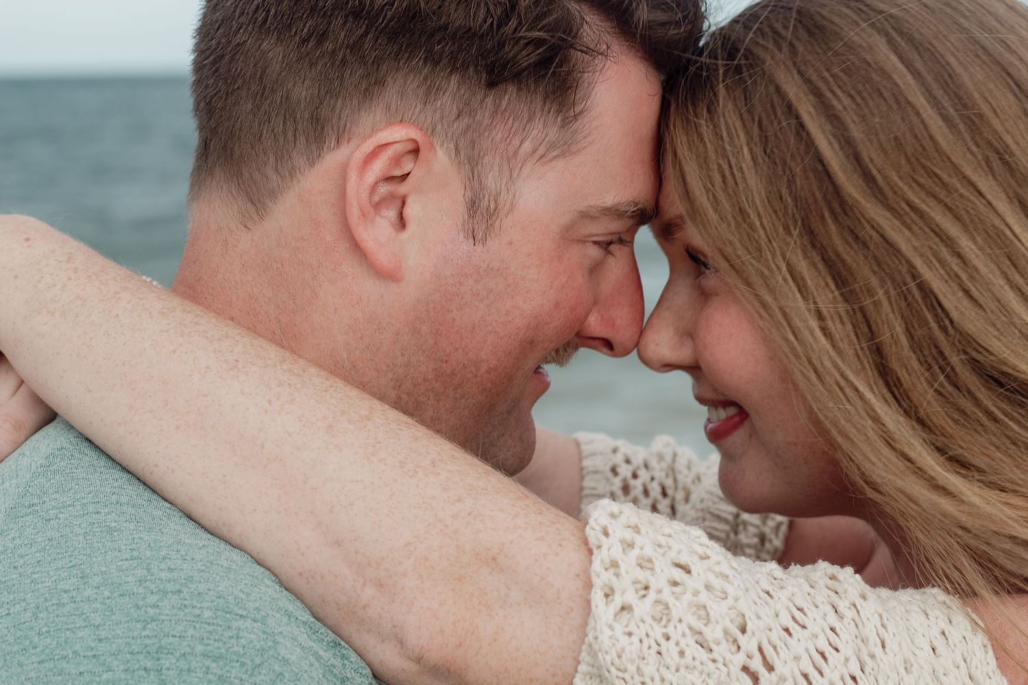 A couple in love shares intimate kisses in a series of romantic close-up photos against a blue background.
