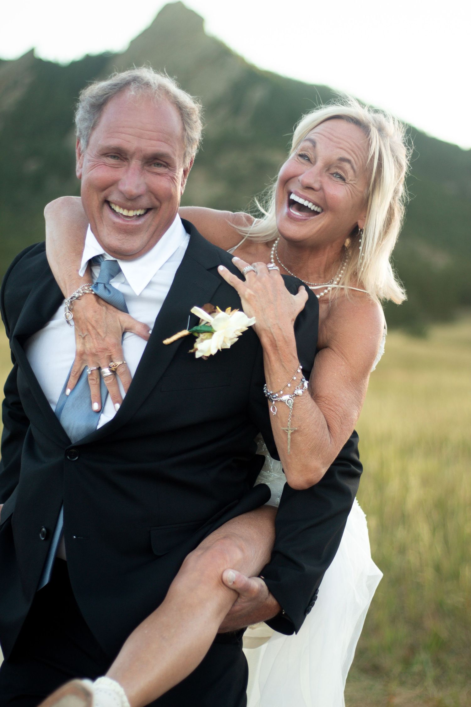 A happy bride and groom share candid laughing moments during their wedding photoshoot in Chautauqua National Park