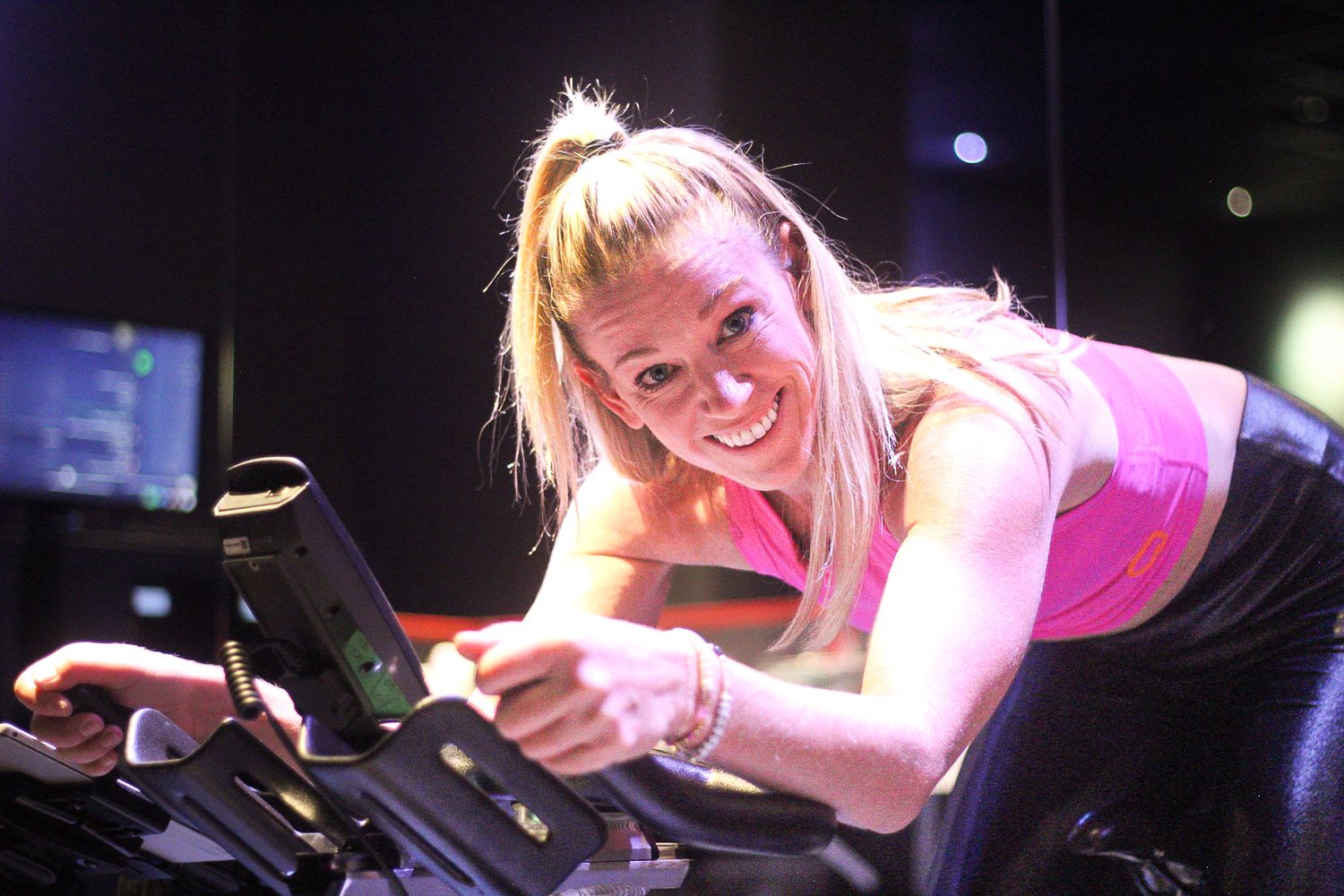Katie Brantley poses on Cyclebar bike in the studio