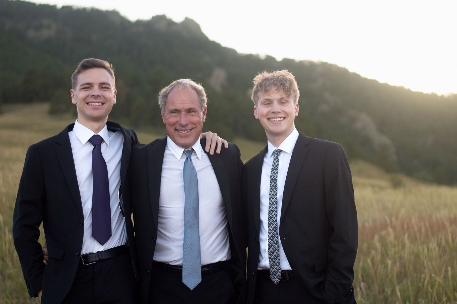 A dad and his sons pose at the father's elopement photo session at Chautauqua Park in Boulder, Colorado
