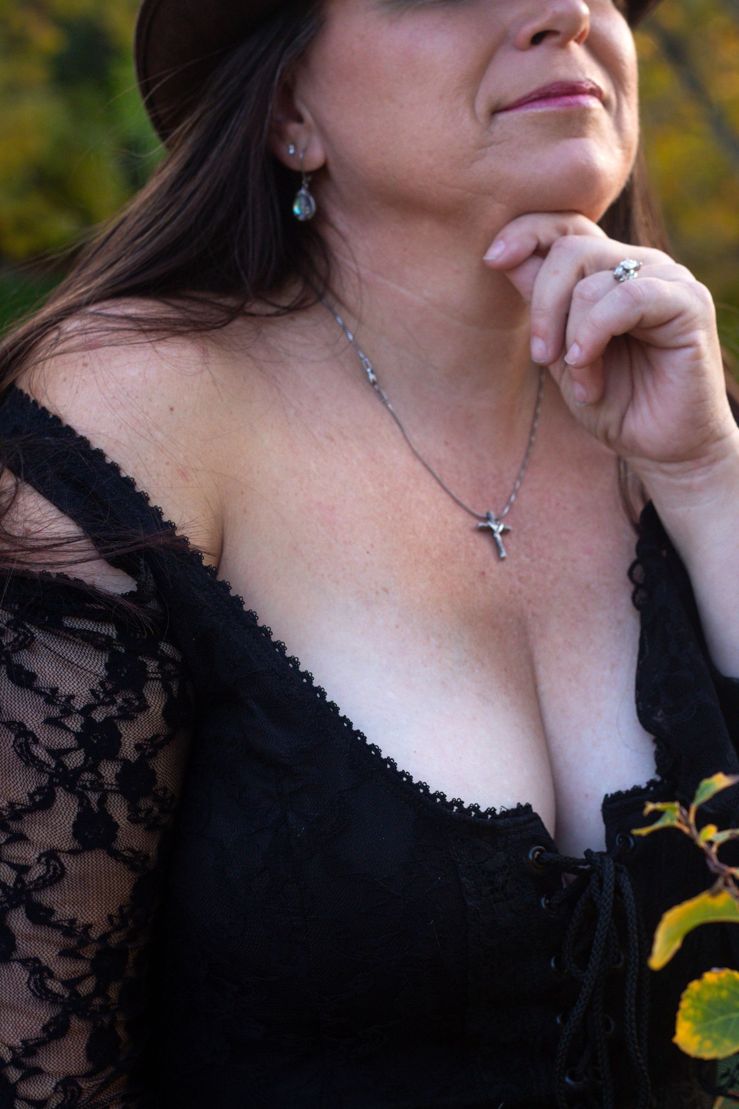 A series of decorative portraiture closeups showing black lace clothing and delicate jewelry against an autumn backdrop.