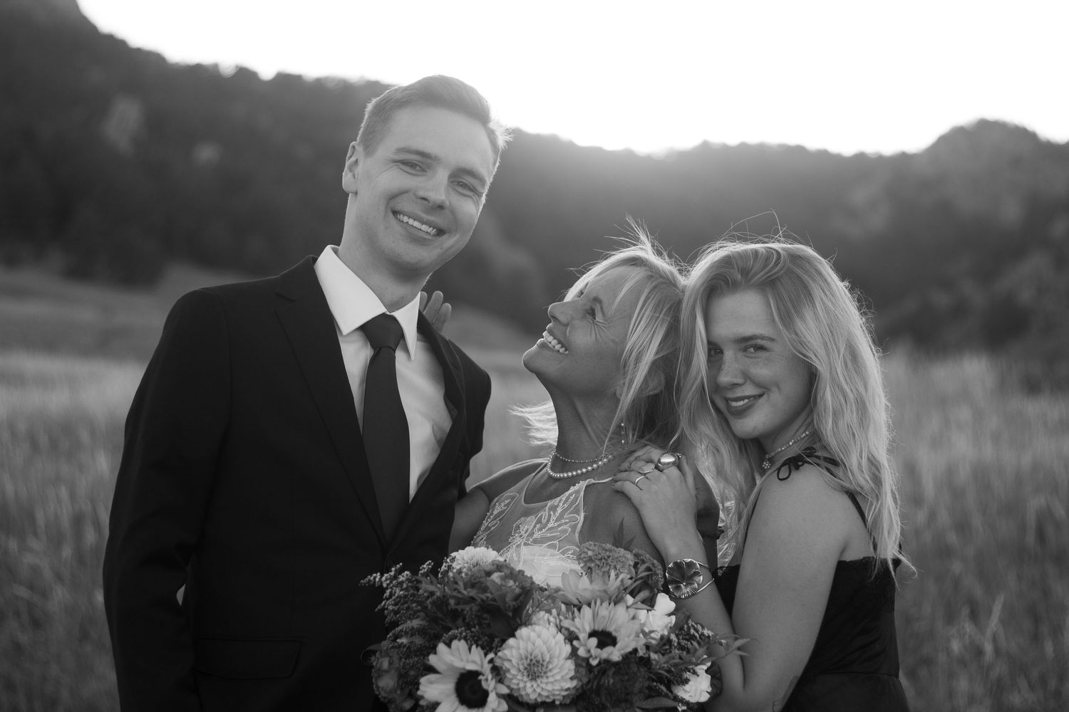 A mother shares a smiling moment with her son and daughter in Chautauqua National Park in Boulder, CO during her elopement.