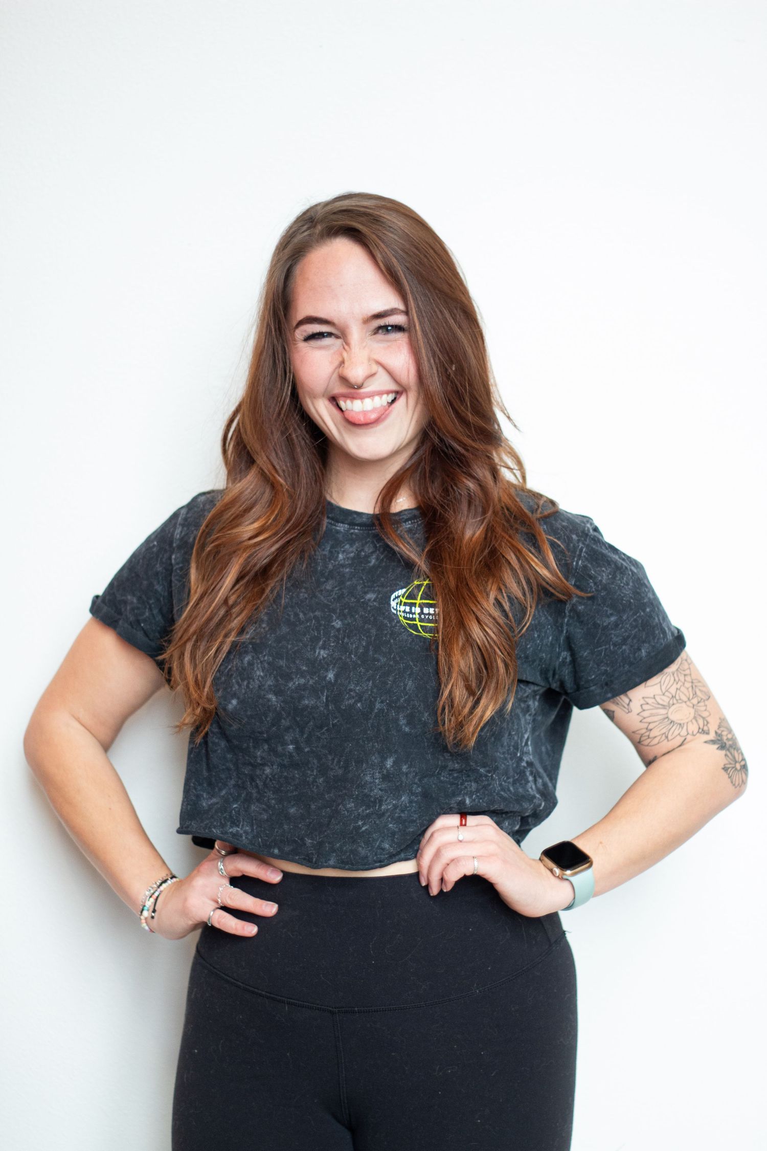 Chloe Voiles sticks out tongue while she places her hands on her hips for a Cyclebar DTC photoshoot