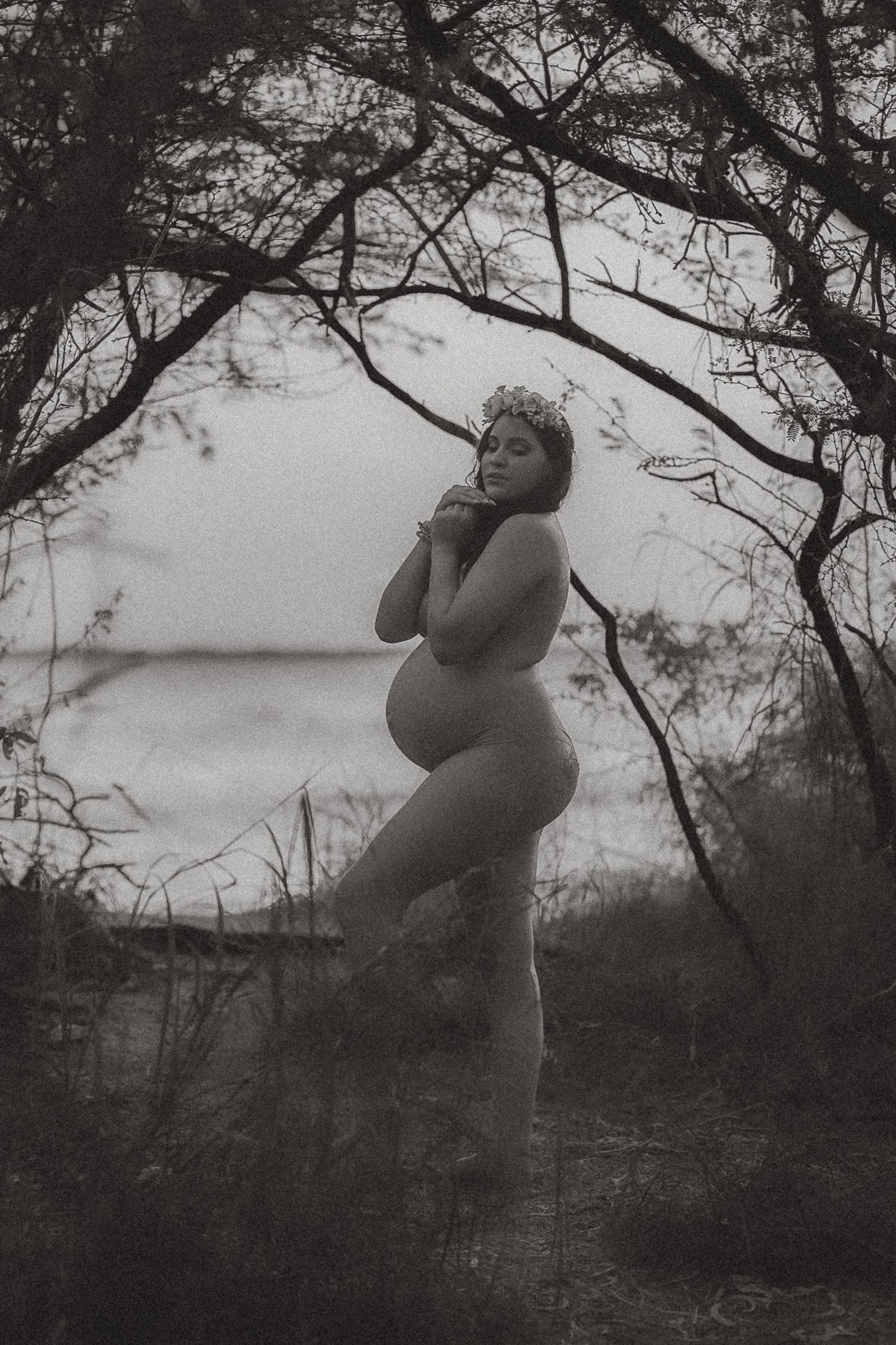 Cinematic outdoor maternity portrait of an expecting mother near the ocean