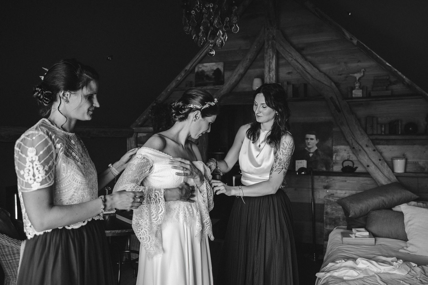 A vintage black and white photograph showing a group preparing for a wedding ceremony.