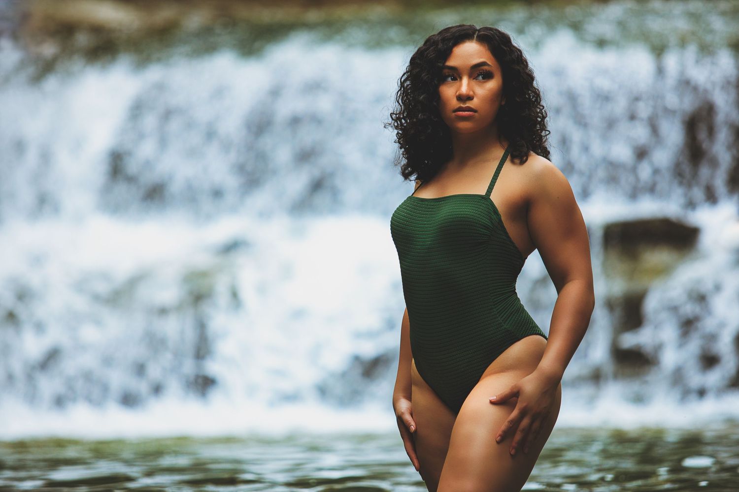 Boudoir Client in Front of Waterfall in Green One-piece Bating Suit