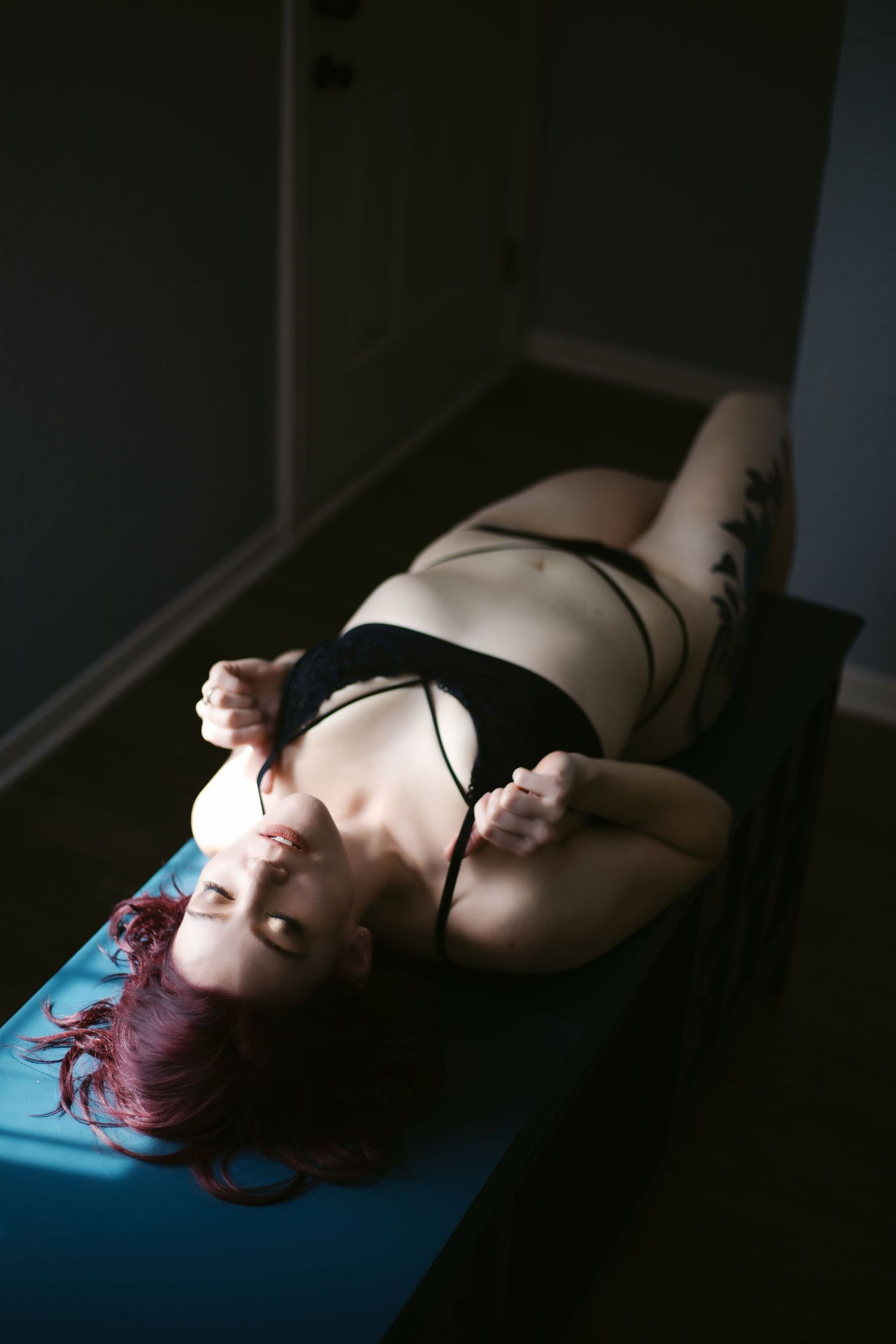 Boudoir Client Posing on Blue Desktop