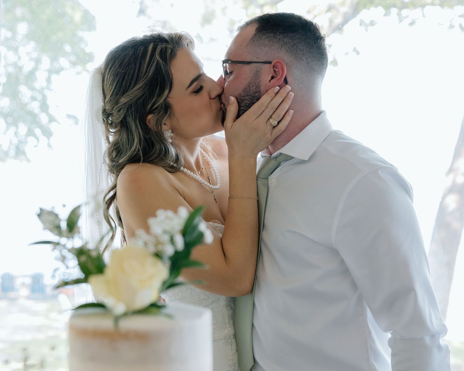 A romantic moment shared between a couple near their wedding cake.