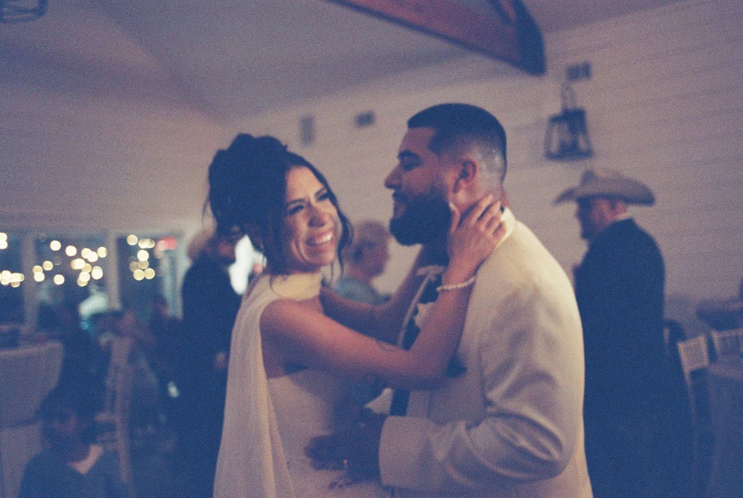 A couple shares an intimate dance moment during their wedding reception.