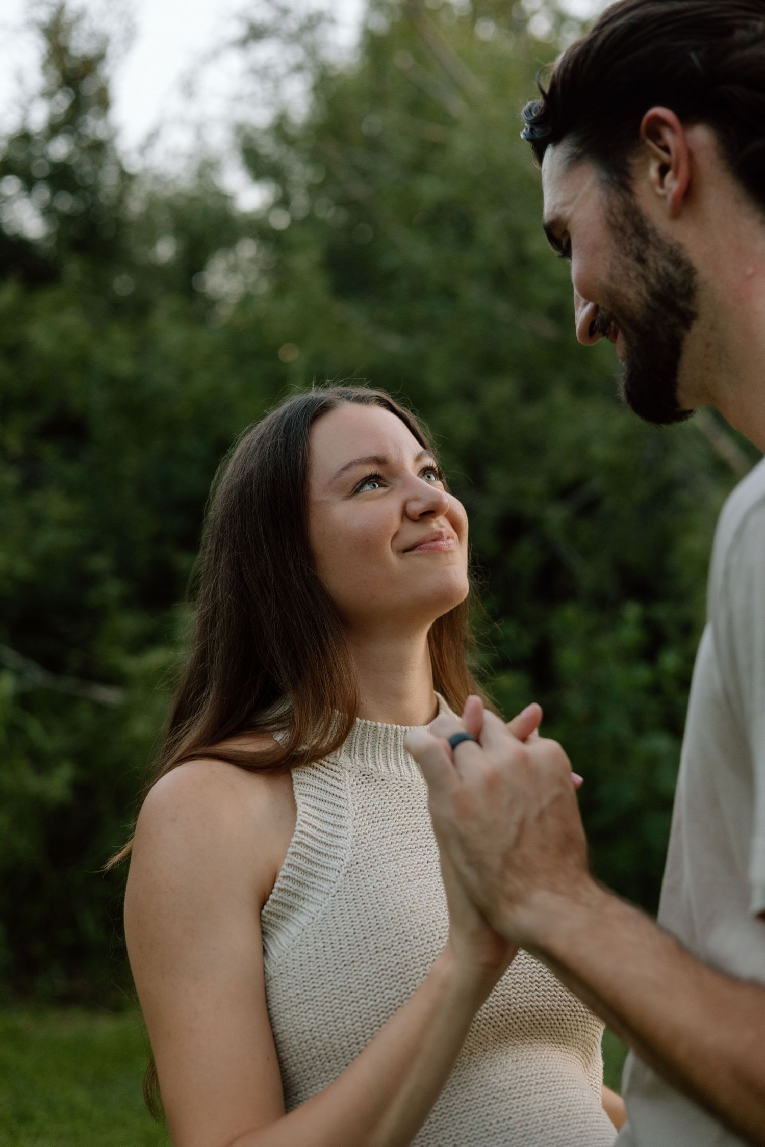 Romantic outdoor maternity photo showing a couple sharing an emotional moment.